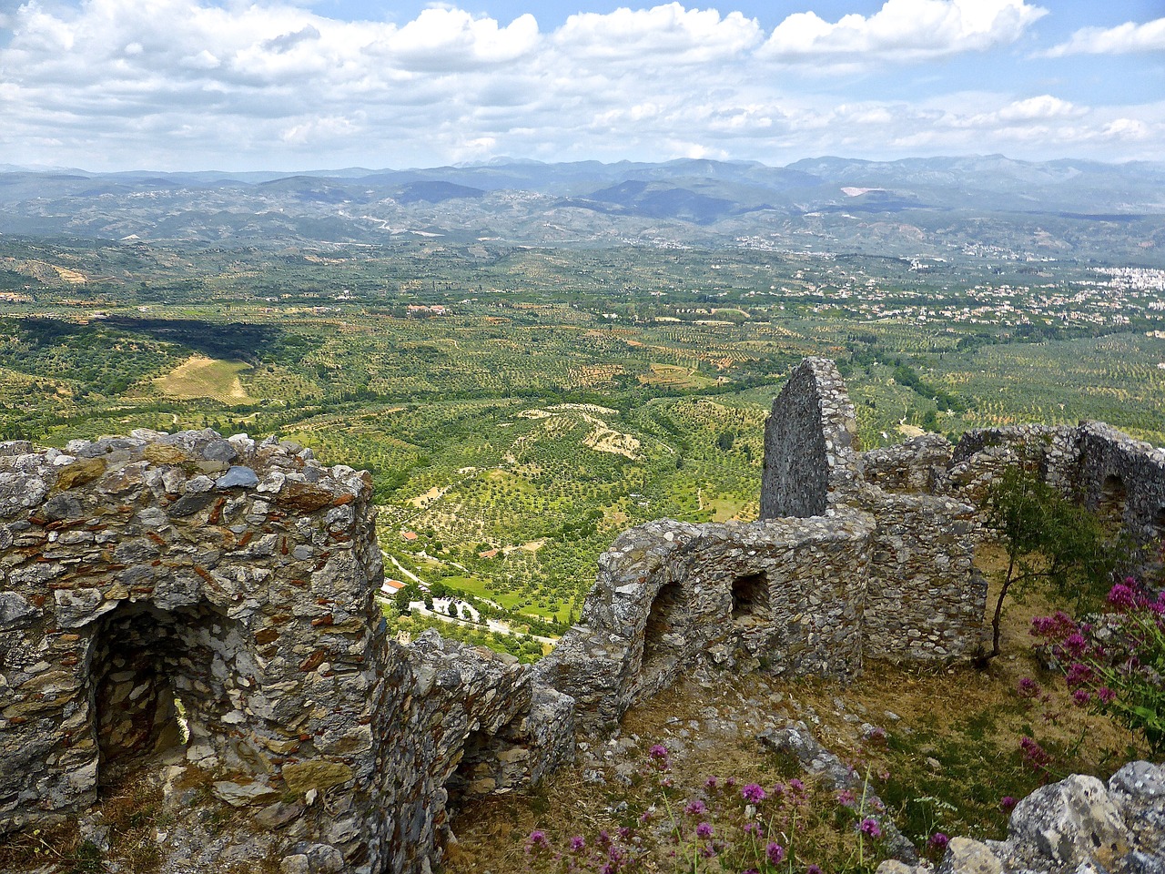 The ruined Byzantine city of Mystras sits on the top and the slopes of a hill that juts out from the plain and is one of the most remarkable places in Greece.